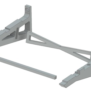 May include: A gray 3D printed stand with two angled supports and a connecting bar. The stand is labeled "ARTEMIS SLS".