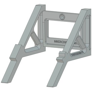 May include: A gray metal stand with a rectangular opening and the text "MERCEDES AMG PETRONAS F1" printed on the front. The stand has two triangular supports on each side.