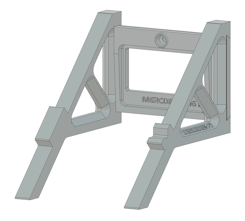 May include: A gray metal stand with a rectangular opening and the text "MERCEDES AMG PETRONAS F1" printed on the front. The stand has two triangular supports on each side.
