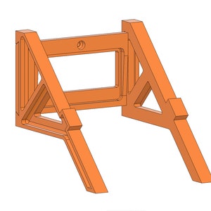 May include: Orange plastic wall mount with a rectangular opening in the center. The mount is designed to hold a device or object.