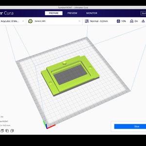 May include: A 3D model of a green plastic object with a rectangular cutout. The model is displayed on a gridded surface in a 3D modeling software program. The software interface includes buttons for "Prepare", "Preview", "Monitor", and "Slice".