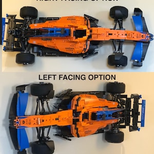 May include: A Lego McLaren Formula 1 race car model in orange, blue, and black. The car is shown from two different angles, one with the front facing right and the other with the front facing left. The car has the words "WebEx by Cisco" printed on the side.