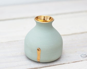 Mint-colored vase with gold applications