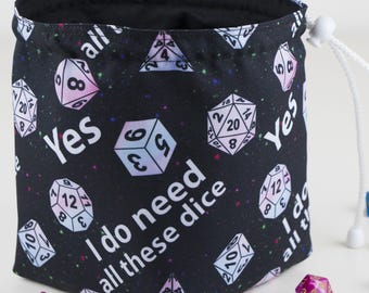 May include: A black dice bag with a galaxy print and the text "Yes I do need all these dice". The bag is made of fabric and has a drawstring closure.