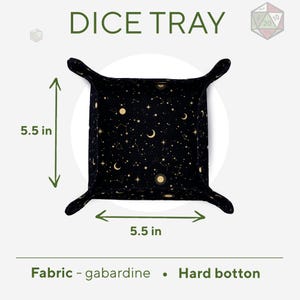 May include: A black dice tray with a gold celestial pattern. The tray is 5.5 inches wide and 5.5 inches long. It is made of gabardine fabric with a hard bottom.