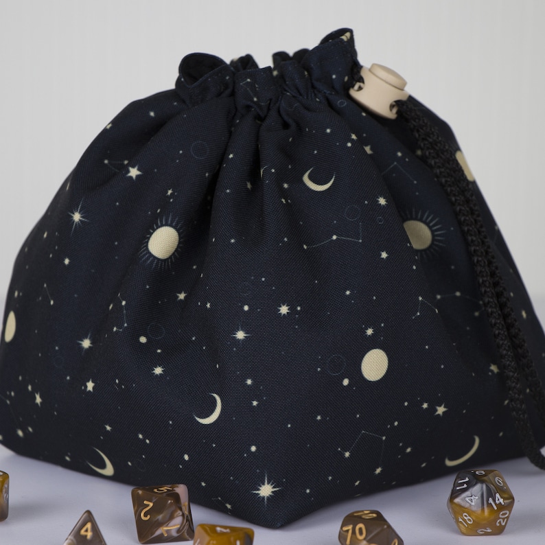 Galaxy dice bag with star pattern on tabletop