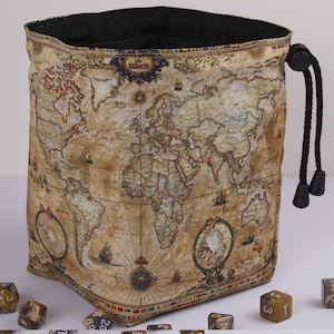 May include: A beige dice bag with a world map design. The bag has a black drawstring closure and a black interior. The map features continents, oceans, and nautical illustrations. Several dice are visible near the bag.