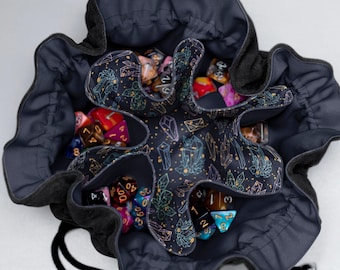 May include: A black velvet dice bag with a drawstring closure. The bag is lined with a fabric featuring a repeating pattern of gold and iridescent crystals on a black background. The bag is filled with a variety of colorful dice.