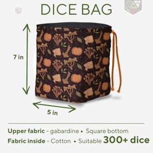 May include: A black dice bag with a mushroom and leaf pattern, featuring an orange drawstring closure. The bag has a square bottom, measures 7 inches in height and 5 inches in width, and is made of gabardine fabric with a cotton interior lining.