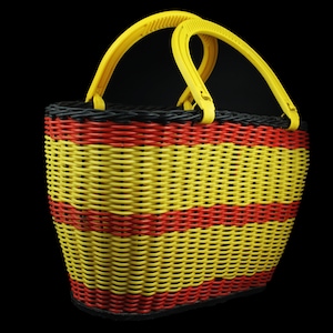 May include: A yellow and red striped wicker basket with black accents and yellow plastic handles.