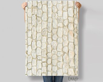 May include: A close-up of a white stone wall with a cobblestone pattern. The stones are irregularly shaped and have a rough texture.