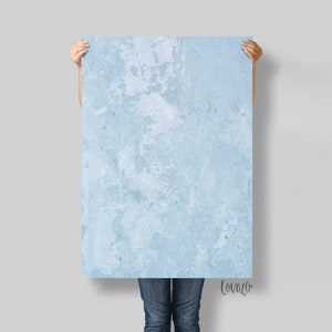 May include: A light blue textured background with a subtle marbled effect. The background is perfect for creating a variety of digital designs.