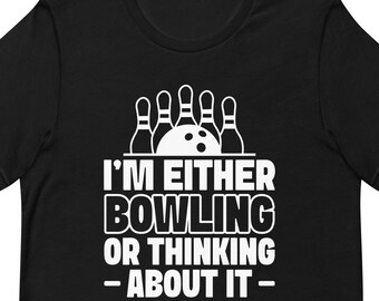 May include: Black t-shirt with a white graphic of bowling pins and a bowling ball. The text reads "I'm either bowling or thinking about it."
