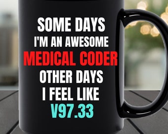May include: Black coffee mug with white text that reads "Some days I'm an awesome medical coder other days I feel like V97.33".