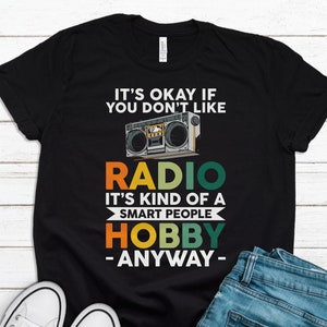 May include: Black t-shirt with a vintage-style boombox graphic and the text "It's okay if you don't like radio. It's kind of a smart people hobby - anyway -."
