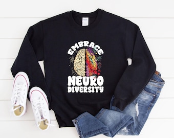 May include: Black sweatshirt with a white graphic of a brain with the text "Embrace Neuro Diversity".