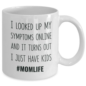 May include: White ceramic coffee mug with black text that reads "I looked up my symptoms online and it turns out I just have kids #momlife".