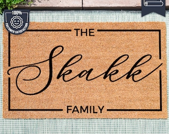 May include: A brown coir doormat with black trim and the text "THE Skakk FAMILY" in a decorative font.