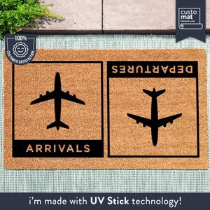 May include: A brown coir doormat with black text and airplane silhouettes. The text reads "Departures" and "Arrivals".
