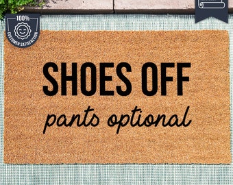 May include: A brown coir doormat with the text "SHOES OFF pants optional" in black lettering. The doormat is made with UV Stick technology.