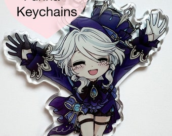 May include: A clear acrylic keychain featuring a chibi-style anime character with white hair, wearing a blue and purple outfit with a crown. The character is smiling and has a blue gem on their chest. The keychain has the text "Genshin Furina Keychains" on it.