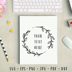 May include: A black and white wreath with leaves and the text "YOUR TEXT HERE" in the center on a white background.