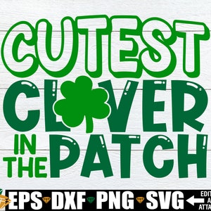 May include: Green and white graphic design with the text "Cutest Clover in the Patch".