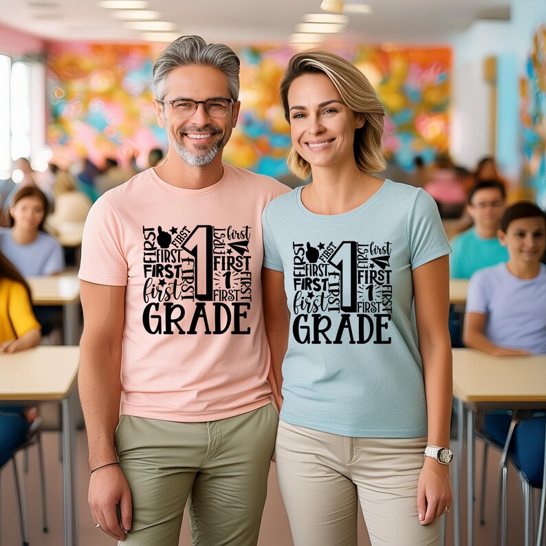 May include: Two people wearing light pink and light blue t-shirts with black text that says "FIRST" and "GRADE" with the number "1" in the center.