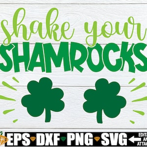 Puede incluir: Gráfico de trébol verde con el texto "Shake your shamrocks" sobre un fondo de madera blanca. El gráfico es perfecto para el Día de San Patricio.