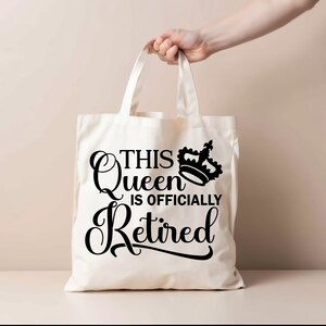 May include: White canvas tote bag with black text that reads "This Queen is Officially Retired" and a black crown graphic.