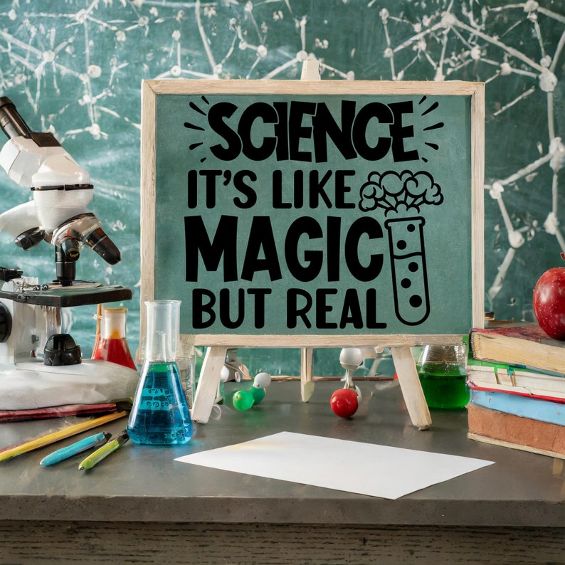 May include: A chalkboard sign with the text "Science it's like magic but real" with a cartoon beaker and a cloud of smoke. The sign is on a wooden easel and there are science-themed items on a table in front of it.