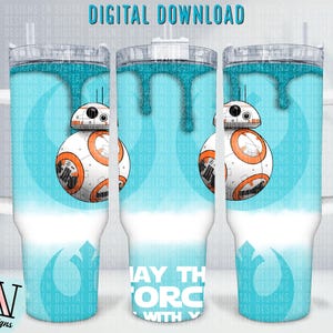 May include: A white tumbler with a blue and white design featuring a Star Wars character, BB-8, and the text "May the Force be with you".