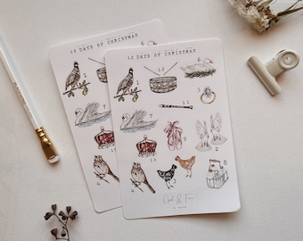 May include: Two white sheets of paper with 12 Days of Christmas stickers. The stickers feature illustrations of the 12 days of Christmas, including a partridge in a pear tree, two turtle doves, three French hens, four calling birds, five golden rings, six geese a-laying, seven swans a-swimming, eight maids a-milking, nine ladies dancing, ten lords a-leaping, eleven pipers piping, and twelve drummers drumming. The stickers are printed on white paper with black text and illustrations.