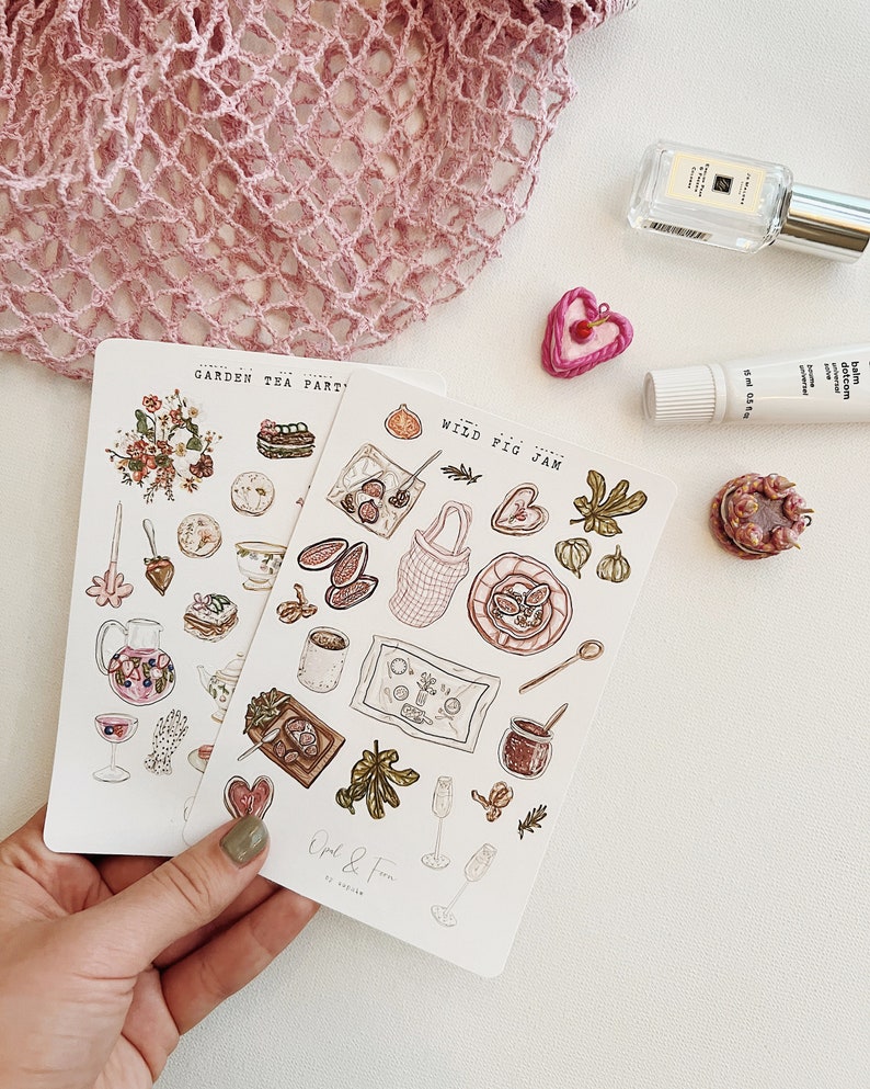 May include: Two sets of stickers featuring illustrations of food and drinks. The first set is titled "Garden Tea Party" and features a teapot, teacups, pastries, and flowers. The second set is titled "Wild Fig Jam" and features figs, jam, bread, and wine glasses.