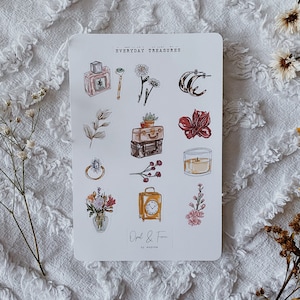 May include: A sheet of stickers with a watercolor design featuring everyday objects like a perfume bottle, a ring, a suitcase, a candle, and flowers. The stickers are labeled "Everyday Treasures" and "Opal & Fern".