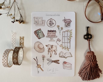 May include: A sheet of stickers with a cottagecore theme. The stickers feature illustrations of a cake, a jar, a window, a book, a cow, a hat, a flower, a key, and a tassel. The sheet is white with the text "Cottagecore" at the top.