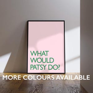 May include: A framed art print with a pink background and the text "WHAT WOULD PATSY DO?" in green. The phrase "MORE COLOURS AVAILABLE" is printed at the bottom in white. The frame is black.