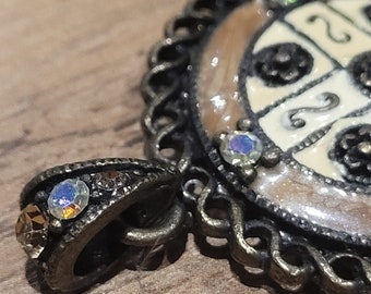Old vintage 1960s Czech brass pendant with enamel and aurora borealis crystals.
