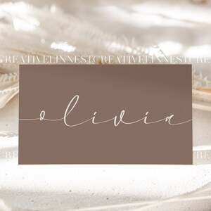 May include: A brown card with the name "Olivia" written in white cursive script.