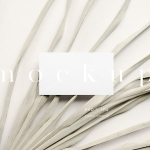 May include: White card mockup on a white background with dried palm leaves. The card is blank and ready for your design.