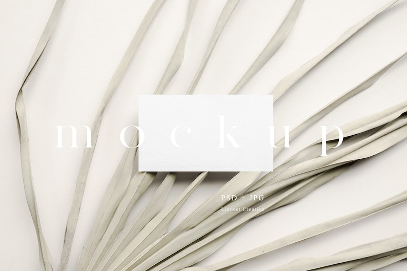 May include: White card mockup on a white background with dried palm leaves. The card is blank and ready for your design.