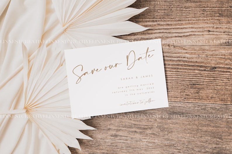 May include: A white save the date card with brown text. The text reads "Save our Date" followed by "Sarah & James are getting married Saturday 7th May 2023 in the Cotswolds. Invitations to follow."