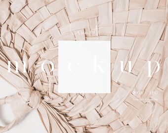 May include: A white card mockup on a woven, light brown, natural material background. The word "MOCKUP" is written in white text on the background.