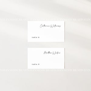 May include: Two white place cards with black text. The top card reads "Catherine Williams" and "table 6". The bottom card reads "Matthew Walker" and "table 9".