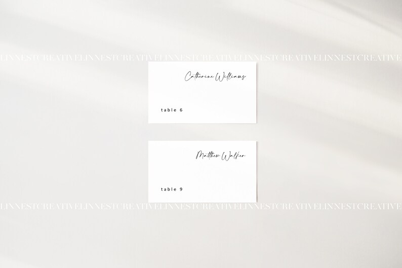 May include: Two white place cards with black text. The top card reads "Catherine Williams" and "table 6". The bottom card reads "Matthew Walker" and "table 9".