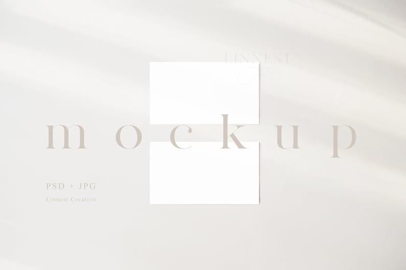 May include: Two blank white cards stacked on top of each other on a white background. The word "mockup" is written in a light gray font below the cards. The text "PSD + JPG" and "Linenat Creative" is written in a light gray font below the word "mockup".