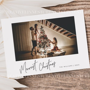 May include: A Christmas card with a photo of a family decorating a Christmas tree. The card reads "Merriest Christmas" and "The Williams | 20XX".