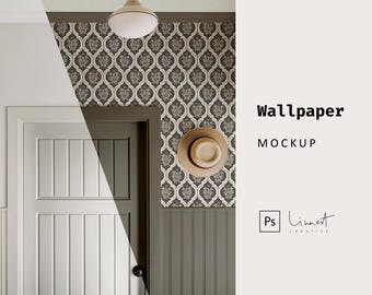 May include: A mockup of a wallpaper design featuring a repeating pattern of stylised floral shapes in beige and brown on a dark grey background. The wallpaper is shown in a room with a white door and a straw hat hanging on the wall.