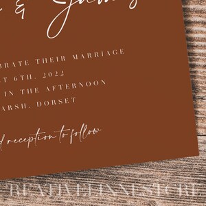 May include: A brown invitation card with white text announcing a wedding. The text reads "To celebrate their marriage on August 6th, 2022 o'clock in the afternoon Tanpit Marsh, Dorset. Dinner and reception to follow."