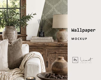 May include: A wallpaper mockup featuring a sage green wall with a white leaf trellis pattern. The scene includes a wooden console table, a ceramic vase with greenery, a reed diffuser, books, a table lamp, and a bowl of decorative spheres.